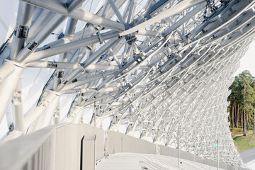 Fototapeta premium Modern architectural design featuring intricate structural elements at a unique outdoor venue surrounded by trees