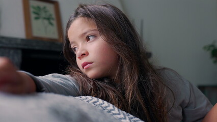 Young girl gazing thoughtfully to the side while resting her arm. A quiet moment of reflection and...