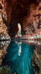 A serene cave with turquoise water reflecting rock formations.