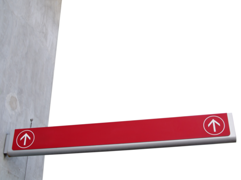 long direction sign with two white straight ahead direction arrows in round frame on grey concrete building corner isolated on transparent