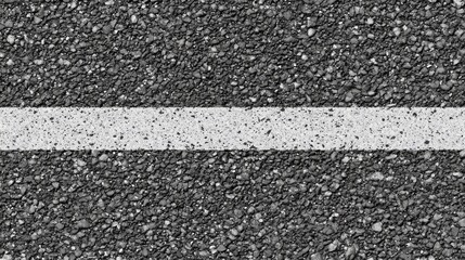 Fototapeta premium Close-up of a white painted line on a black asphalt surface.