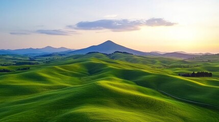 Fototapeta premium Rolling Green Hills and Mountains at Sunset