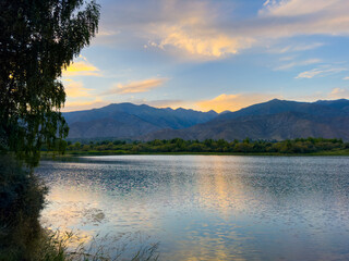 A quiet mountain lake Issyk-Kul, surrounded by green valleys and majestic mountains. The perfect...