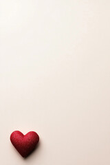 Fototapeta premium Glitter cushion in the shape of heart isolated on pale pink background.