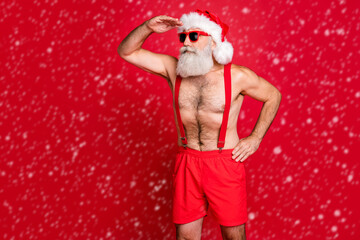 Portrait of his he nice attractive content serious focused attentive gray-haired man St Saint Nicholas looking far away wintertime isolated over bright vivid shine red background