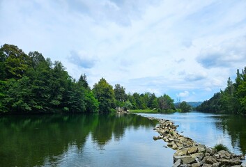 Day trip to a calm riverside in forest, a walk over the stone path in the river