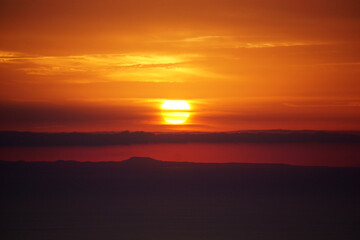 The big red sun during sunset over the sea