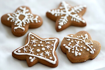 A collection of festive gingerbread cookies, capturing the warm holiday spirit with intricate icing designs and traditional shapes like stars, hearts, and gingerbread people.