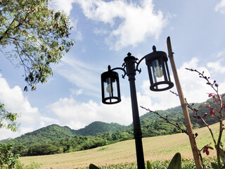 Lamppost against a backdrop of mountains and sky