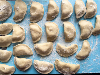 Uncooked ukraine vareniki dumplings tortellini home hand made with potatoes and onion