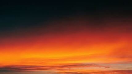 Obraz premium Fiery sunset sky. Burning horizon, vibrant colors paint the evening sky. A breathtaking scene of hope and renewal.