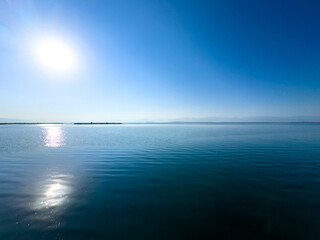 A horizontal line of water and sky with a smooth transition of colors. The calm and vastness of Lake Issyk-Kul.