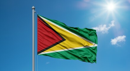 Guyana national flag waving on a sunny day against a clear blue sky.