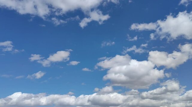 White cumulus clouds moving across the beautiful sky at midday