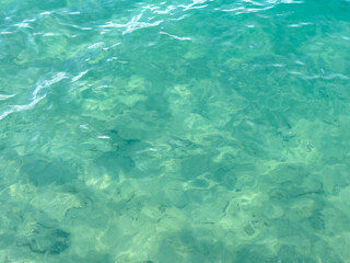 Texture of blue calm water creates a serene and peaceful background. The natural beauty of water reflects the essence of nature, evoking a sense of tranquility reminiscent of the sea.
