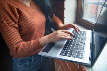 Business woman hands typing on laptop computer keyboard