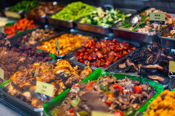 Traditional Asian dishes sold in a food court in Singapore