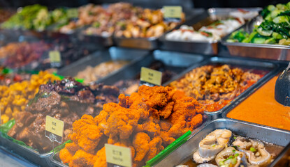 Traditional Asian dishes sold in a food court in Singapore