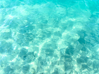 Texture of blue calm water creates a serene and peaceful background. The natural beauty of water reflects the essence of nature, evoking a sense of tranquility reminiscent of the sea.
