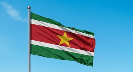 Obraz premium Suriname national flag waving against blue sky.