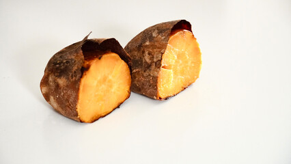 Baked sweet potatoes on a white background.
