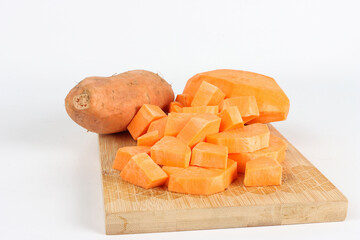 Sweet potato on a wooden cutting board