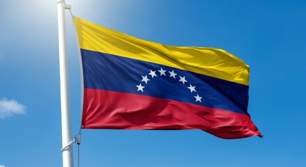 Venezuelan flag waving against a clear blue sky.