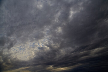 Panoramic view of the sky with gray clouds covering it, overcast and windy weather, sky background.
