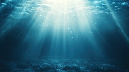Underwater background with light rays shining through the water surface, creating an atmosphere of tranquility and depth. The blue color scheme adds to its serene charm.