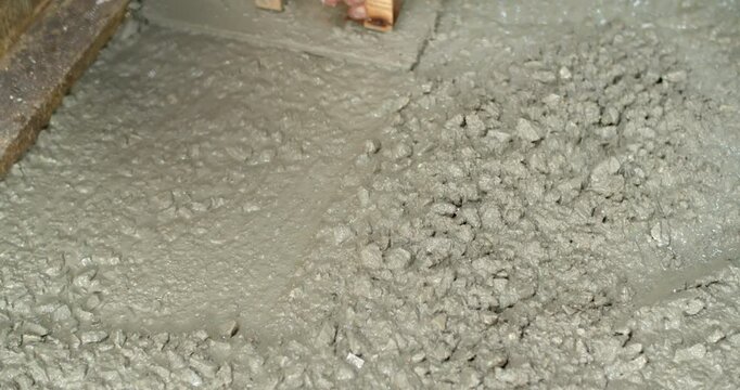 Spread the cement with Plastering trovel.Hand Holding Trowel and Smoothing Out the Plastering Concrete.Pouring cement for smooth areas.Cement flooring instead of ground.	