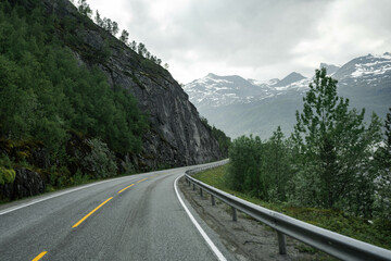 Empty road in a moody norway mountain landscape