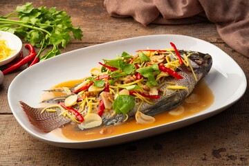 Steamed Tilapia fish with Soybean Paste sauce in white plate