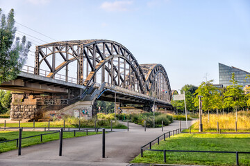 Naklejka premium Frankfurt, Germany - July 29, 2024: The Deutschherrnbrücke railway bridge over the River Main in Frankfurt 