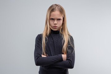Portrait of stubborn young girl crossing arms with angry express
