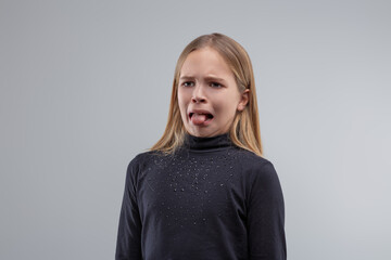 Young girl showing disgust sticking out tongue,