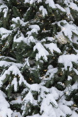 Christmas trees decorated with gold and red balloons in front of the cafe entrance. Street New Year decorations.