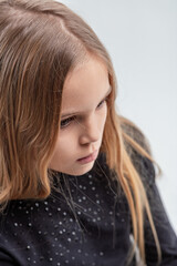 Portrait of pensive child reflecting on white background