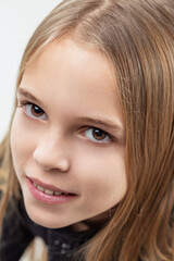 Portrait of smiling young girl with expressive brown eyes and lo