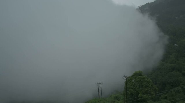 Handheld 4K video of monsoon clouds passing over Himalayan mountains of Darjeeling, West Bengal, India. Darjeeling is queen of hills and very scenic with beautiful green hills in rainy season.