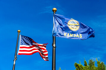 Real photo of Kansas State flag and United States of America Flag waving in the wind