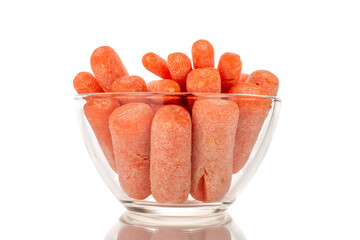 Several peeled small carrots in a glass plate, macro, isolated on white background.