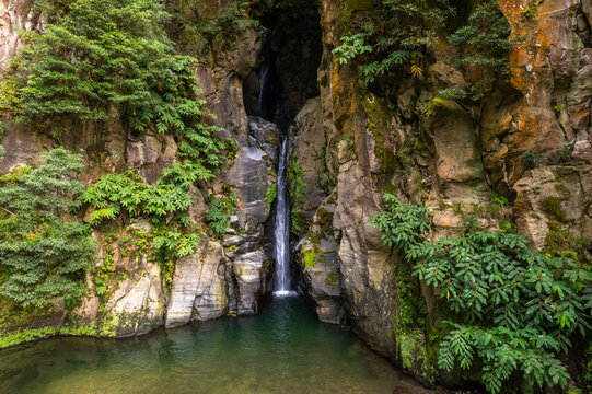 Salto do Cabrito Waterfall in Azores with Rocky Cliffs and Verdant Foliage - Serene Natural Pool and Tropical Vegetation - Ideal for Nature Prints, Digital Backgrounds