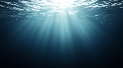 Deep blue ocean bathed in golden sunlight, a stunning underwater scene 