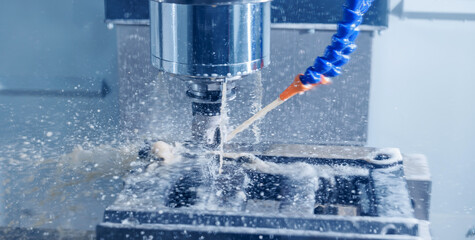 Working closeup CNC turning cutting metal Industry machine iron tools with splash cutting fluid...