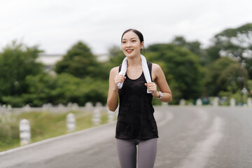 Fitness Journey: A radiant young woman, her face glowing with determination, strides confidently...