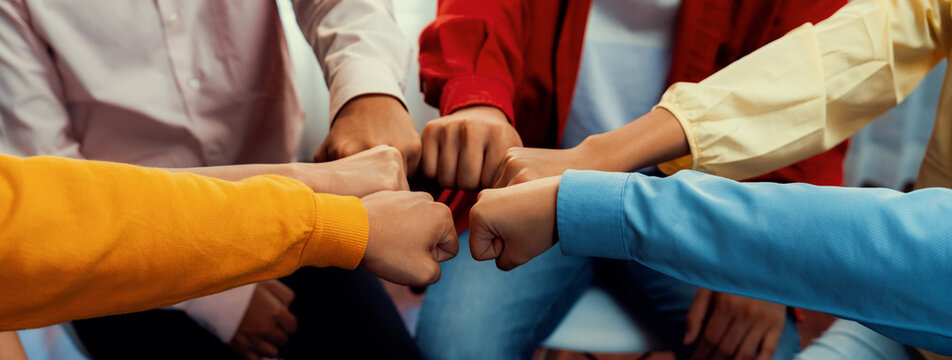 Startup company employee team stacking hand together symbolize successful group of business partnership and strong collective unity teamwork in community workplace in panoramic banner. Synergic