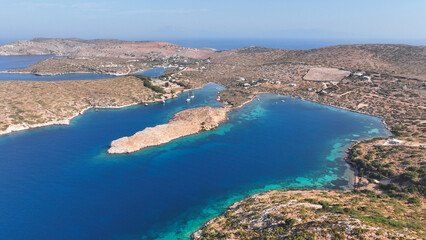 Aerial drone photo of yachts and sail boats anchored in tropical exotic island complex with crystal clear turquoise sea forming a blue lagoon