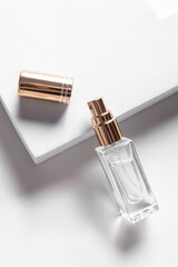 Small glass perfume bottle with open golden cap. Small volume of perfume