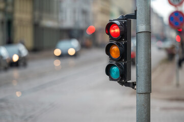 traffic light on the street junction with beautiful bokeh, city with cars in the background