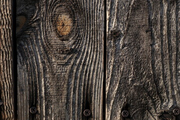 Close-up of weathered wooden planks with visible grain and knots. Natural wood texture with aged appearance © Maciej Bonk